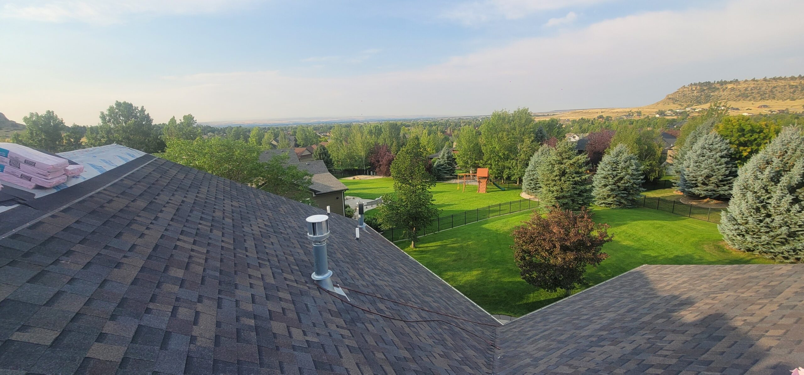 image from a rooftop looking out over a green landscape with trees